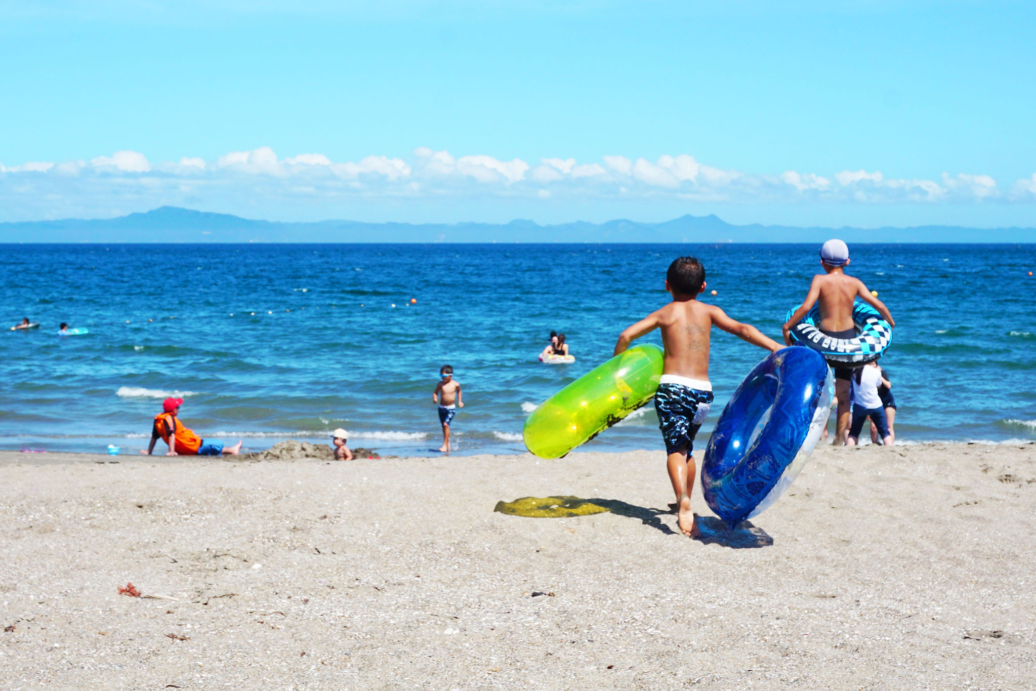 Children out in a sunny day at the beach.